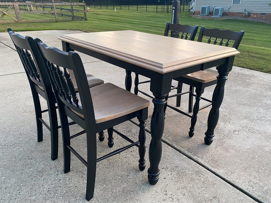 An Ashley Furniture dining room table that is a pub-style table.  It has been refinished by The Sociable Home, which changes it to greige tones.